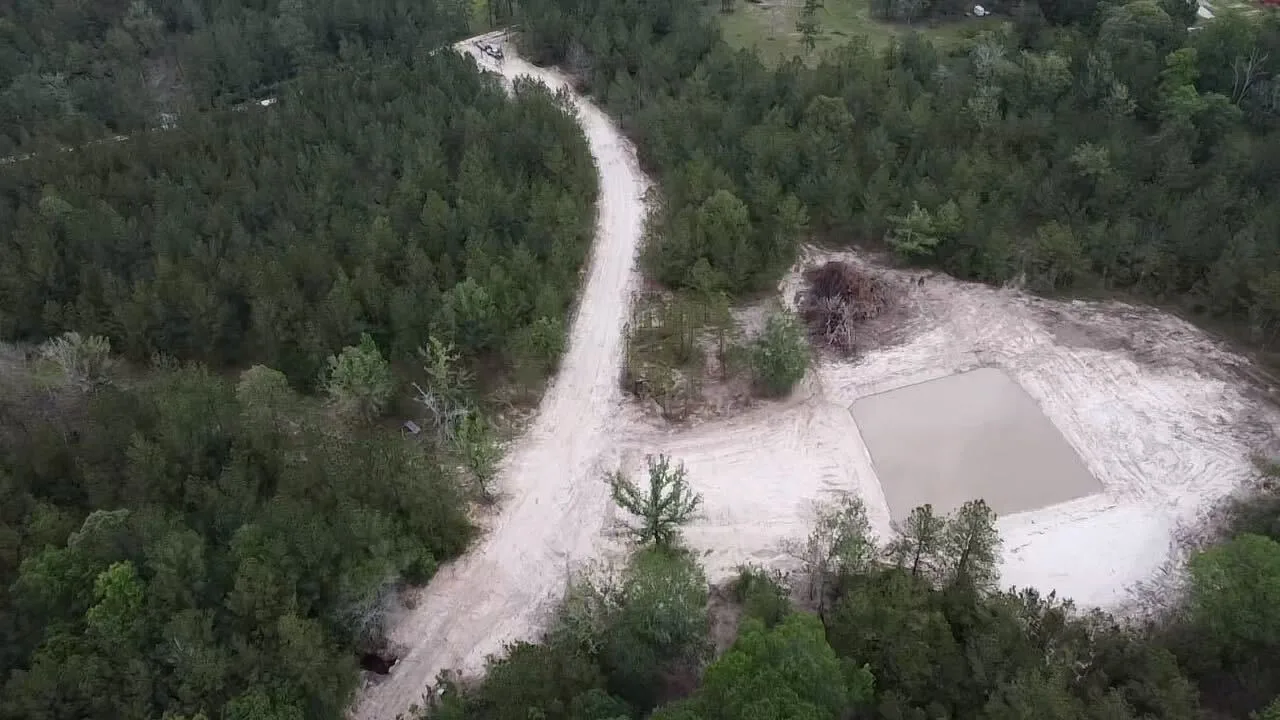 Aerial of a pond pad and the sand road cut to reach it
